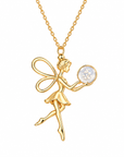 A gold fairy pendant necklace on a matching chain, featuring a gold fairy holding a round white opal-like gemstone, set against a plain white background.