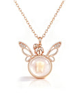 A rose gold necklace featuring a fairy-themed pendant with wings, a small fairy figure, and a round bezel containing a white tooth, shown on a clean white background.