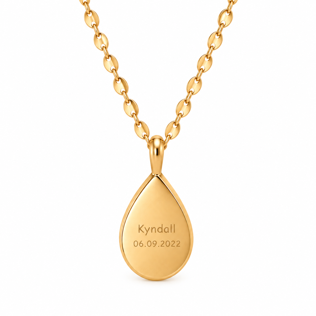 A gold teardrop pendant necklace engraved with the name 'Kyndall' and the date '06.09.