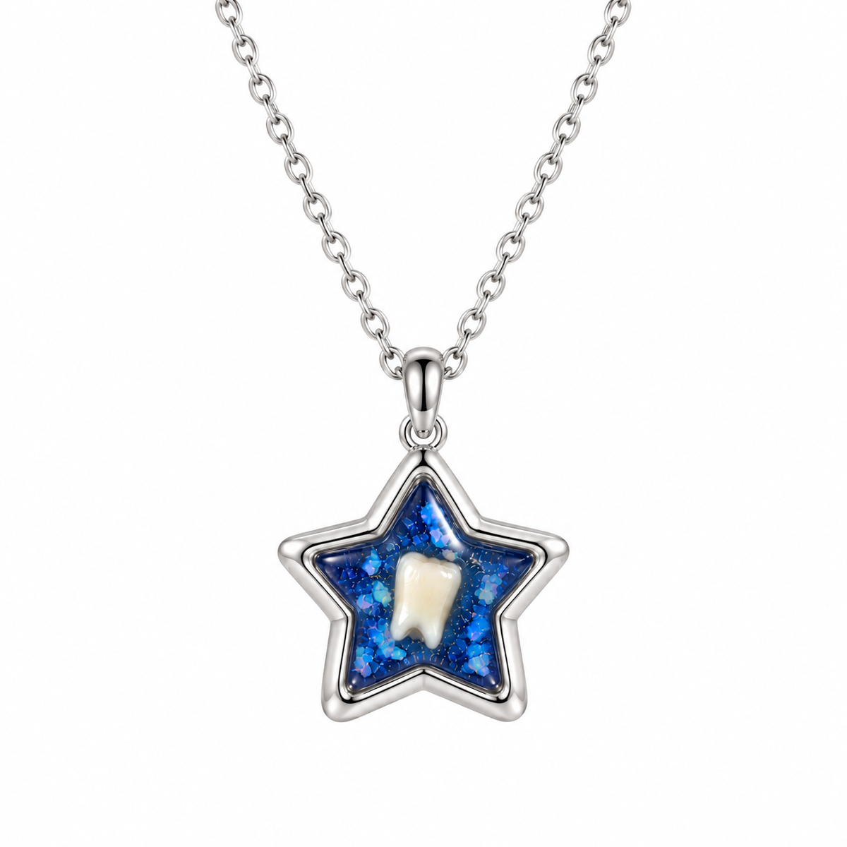 A silver star-shaped pendant necklace featuring a blue glittery background with a small white tooth in the center, suspended from a silver chain on a white background. Baby tooth keepsake.