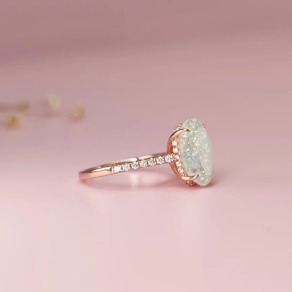 Rose gold ring with a large ash / cremation gemstone on a pink background